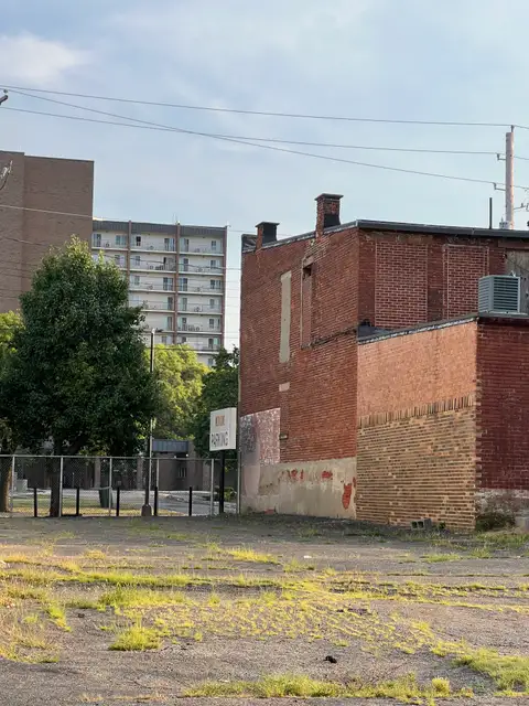City layers: old brick meets modern sky.